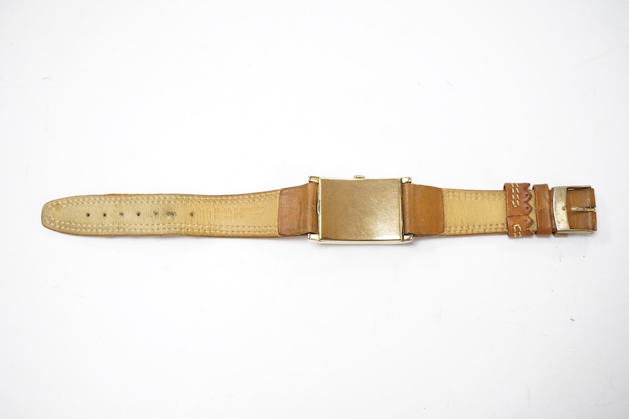 A gentleman's 1930's/1940's 14k gold Zenith manual wind wrist watch, with rectangular Arabic dial and subsidiary seconds, case diameter 25mm, on a later associated leather strap. Condition - fair